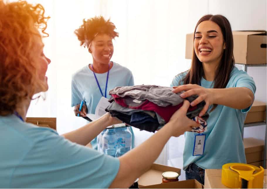 Student passing folded clothing between each other