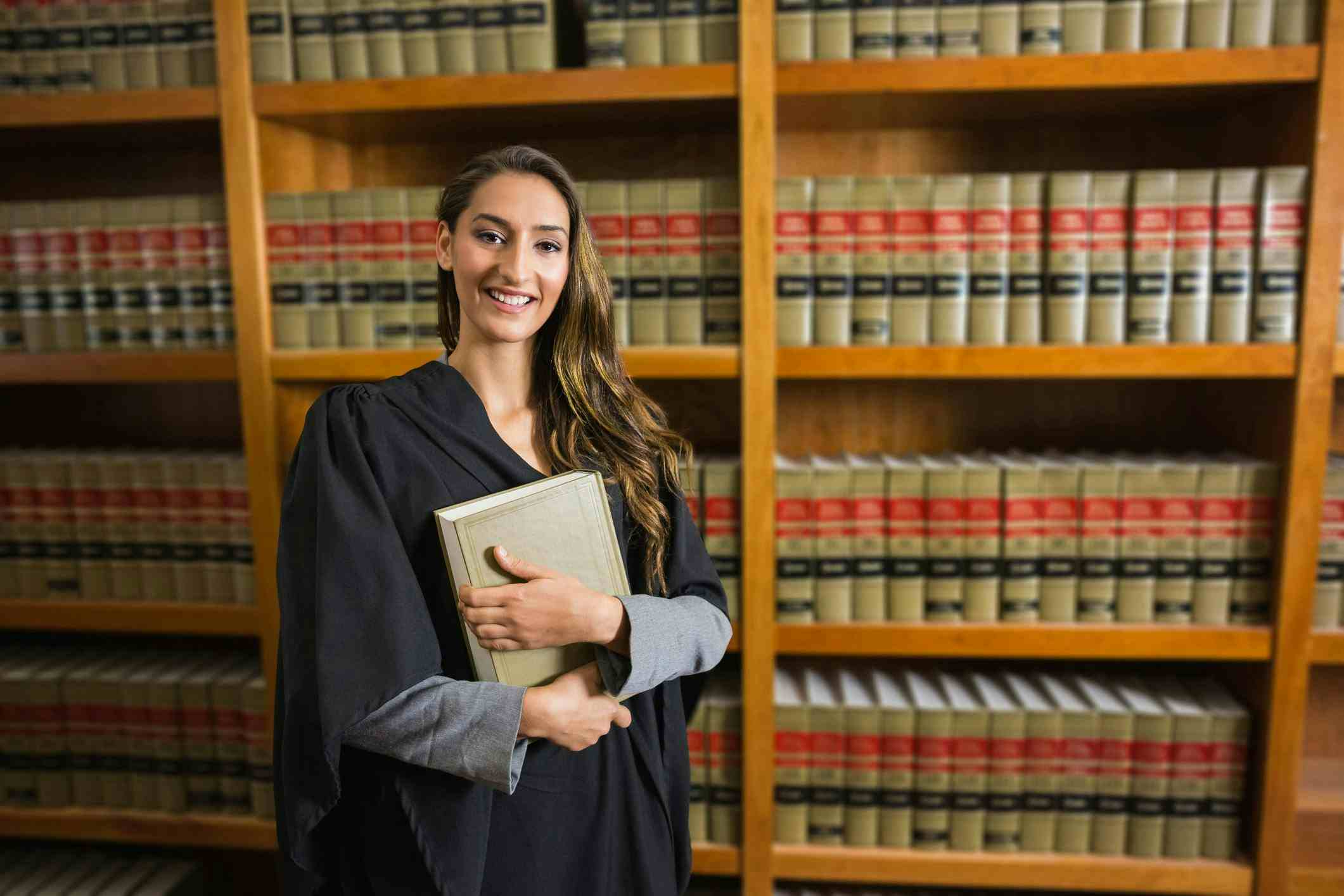 Woman in a university law library holding a book