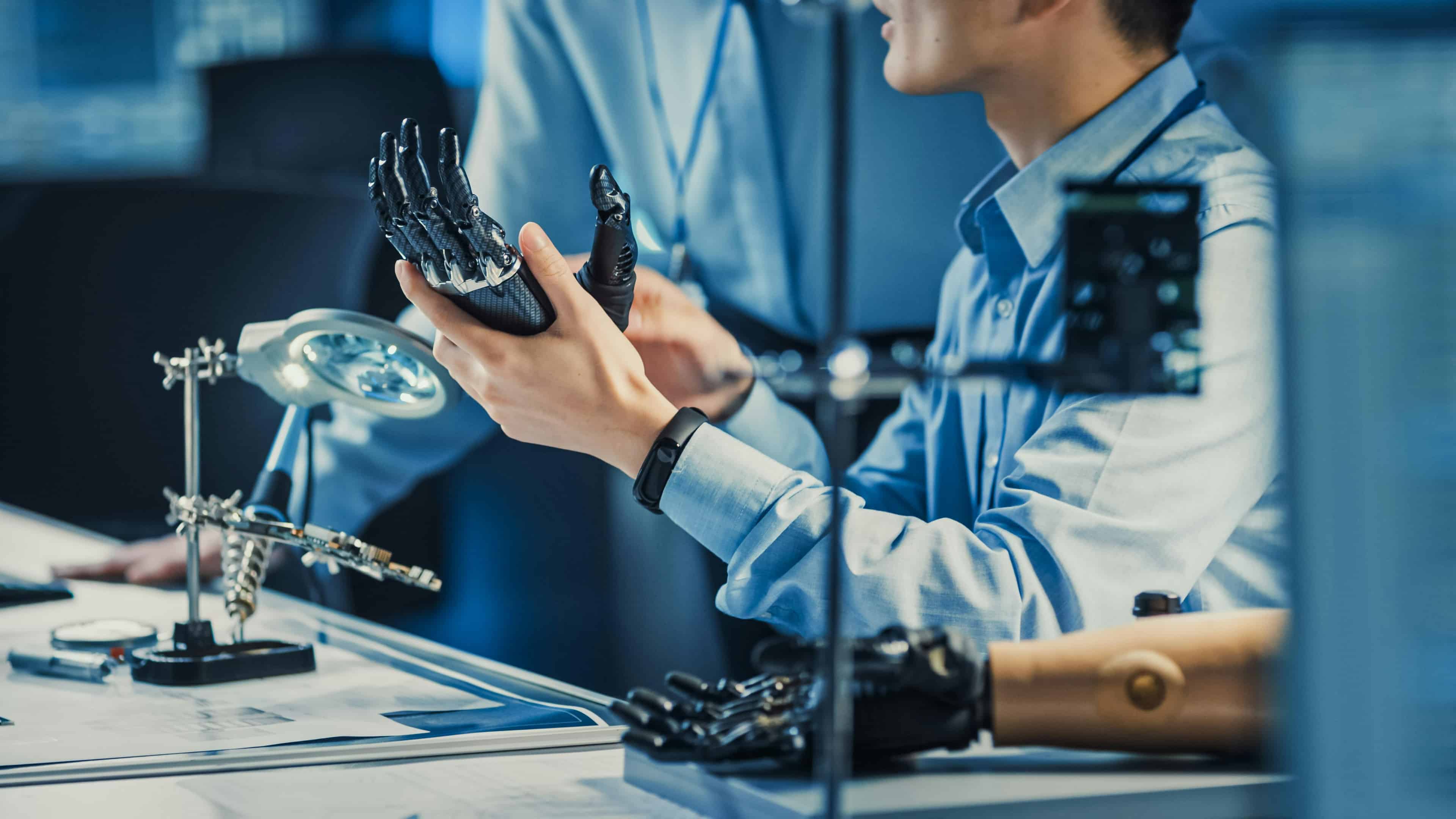 Man in a lab holding an engineered hand