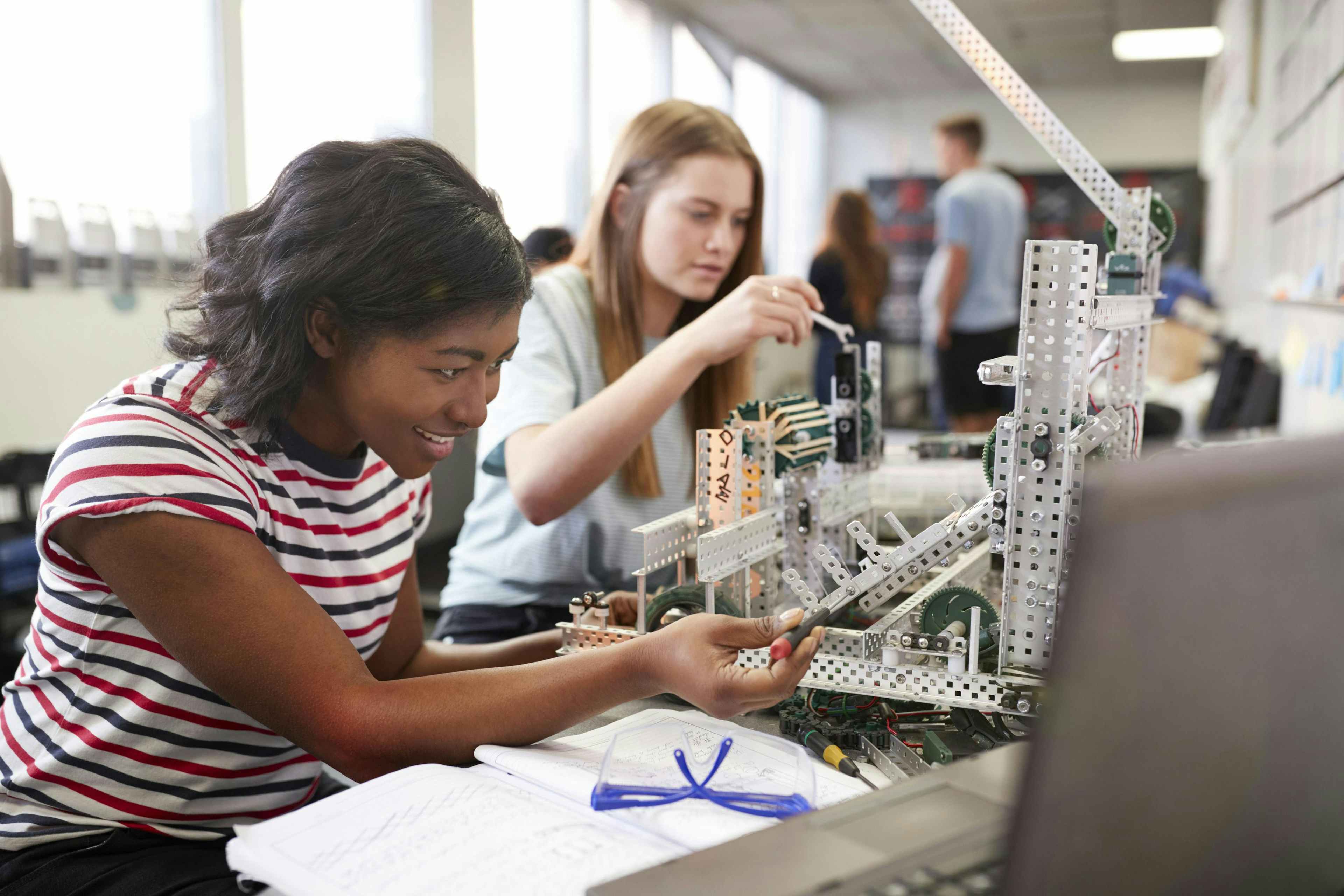 Two high school students working on an engineering and technological project