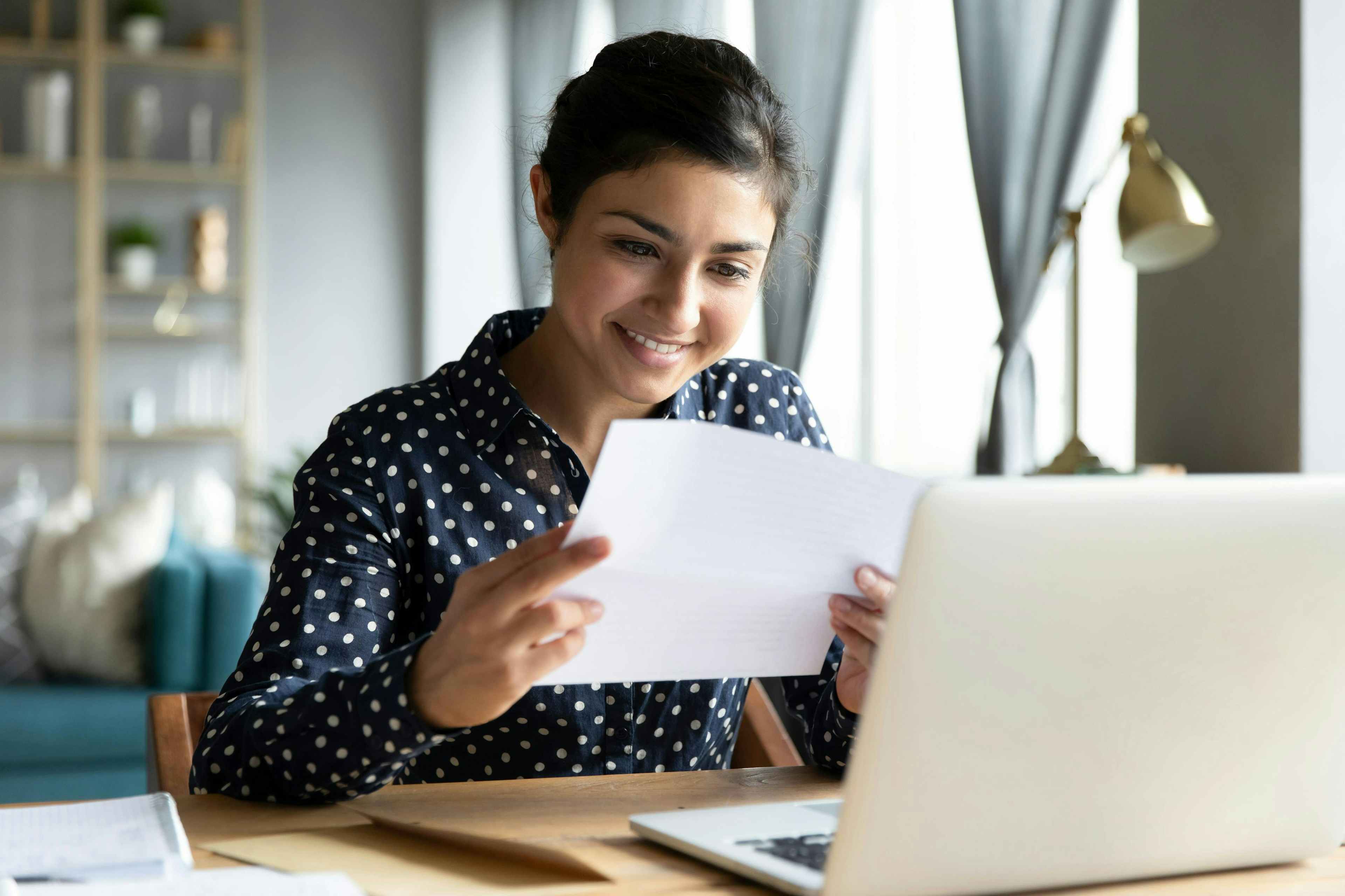 High School student at their desk with their laptop looking at a letter of recommendation