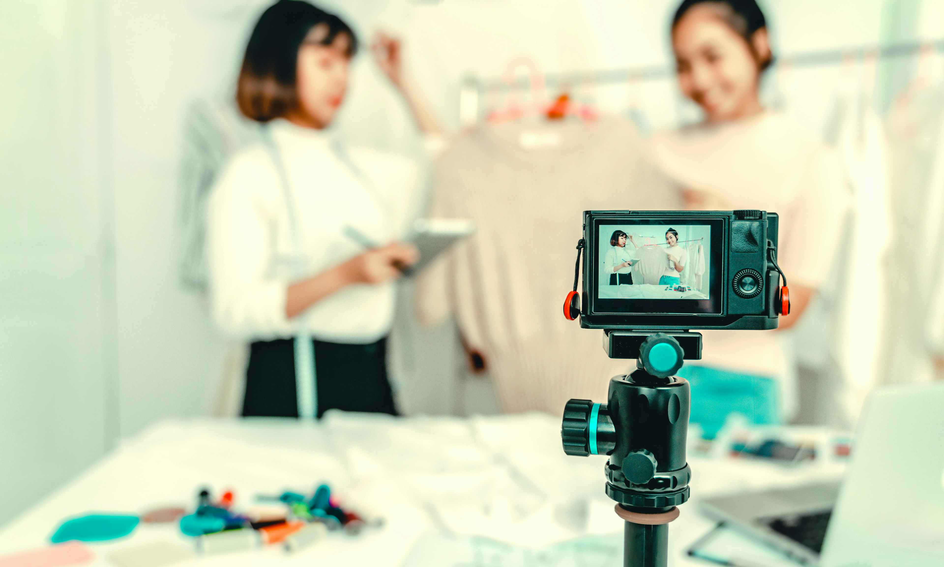 Two students recording a video of their fashion brand