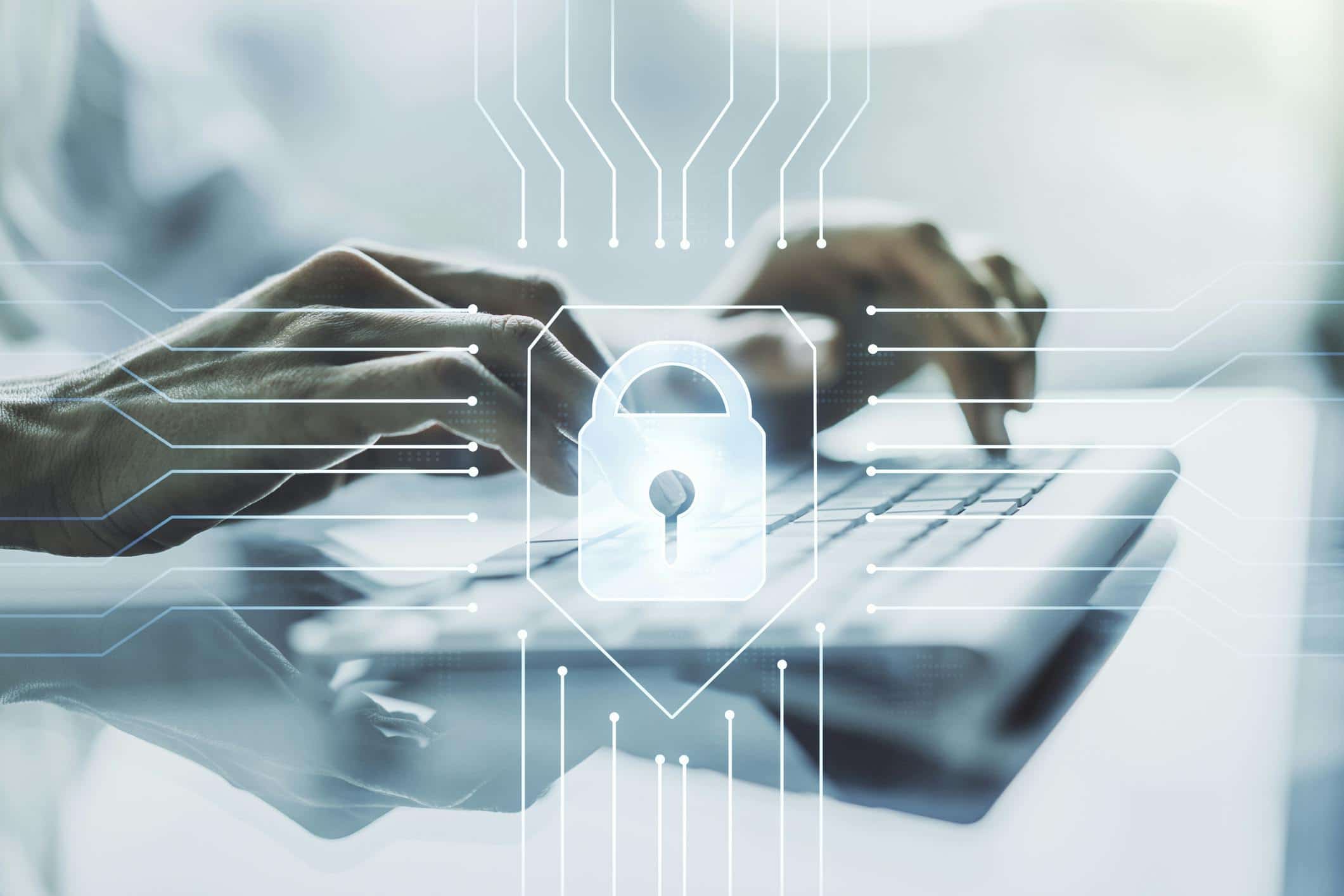 Hands typing on a laptop keyboard with a digital overlay of a lock symbol, representing cybersecurity and data protection in a high-tech environment.