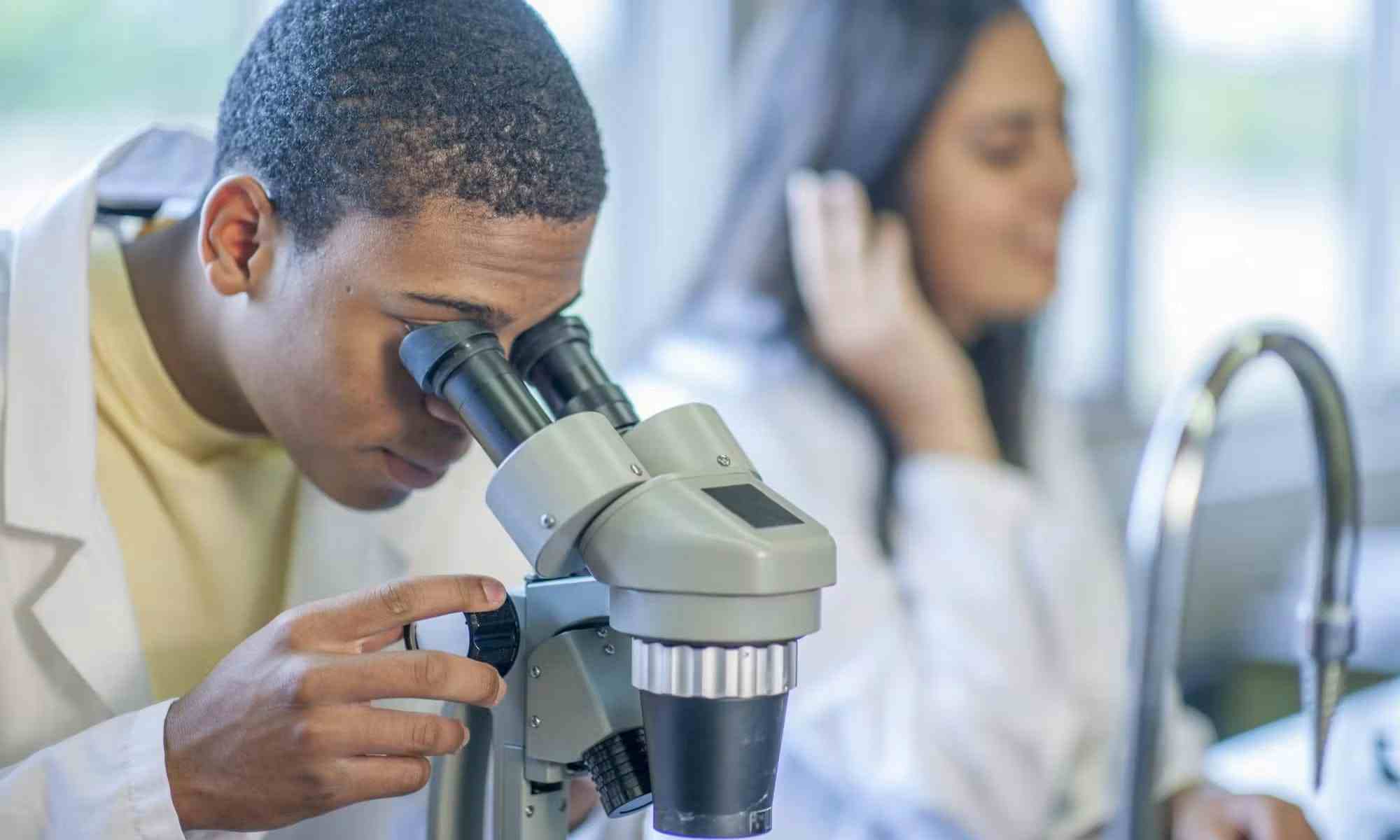 High School student studying medicine using microscope