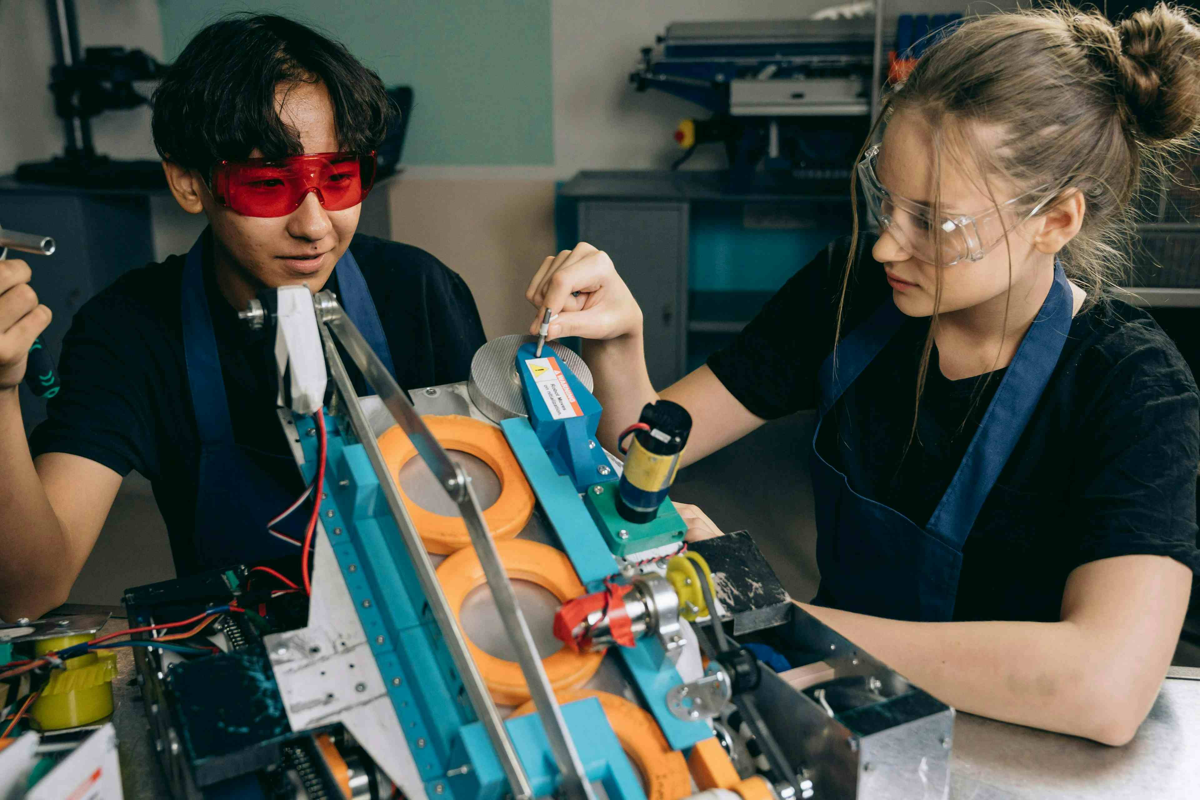 High school boy and girl working on a robot