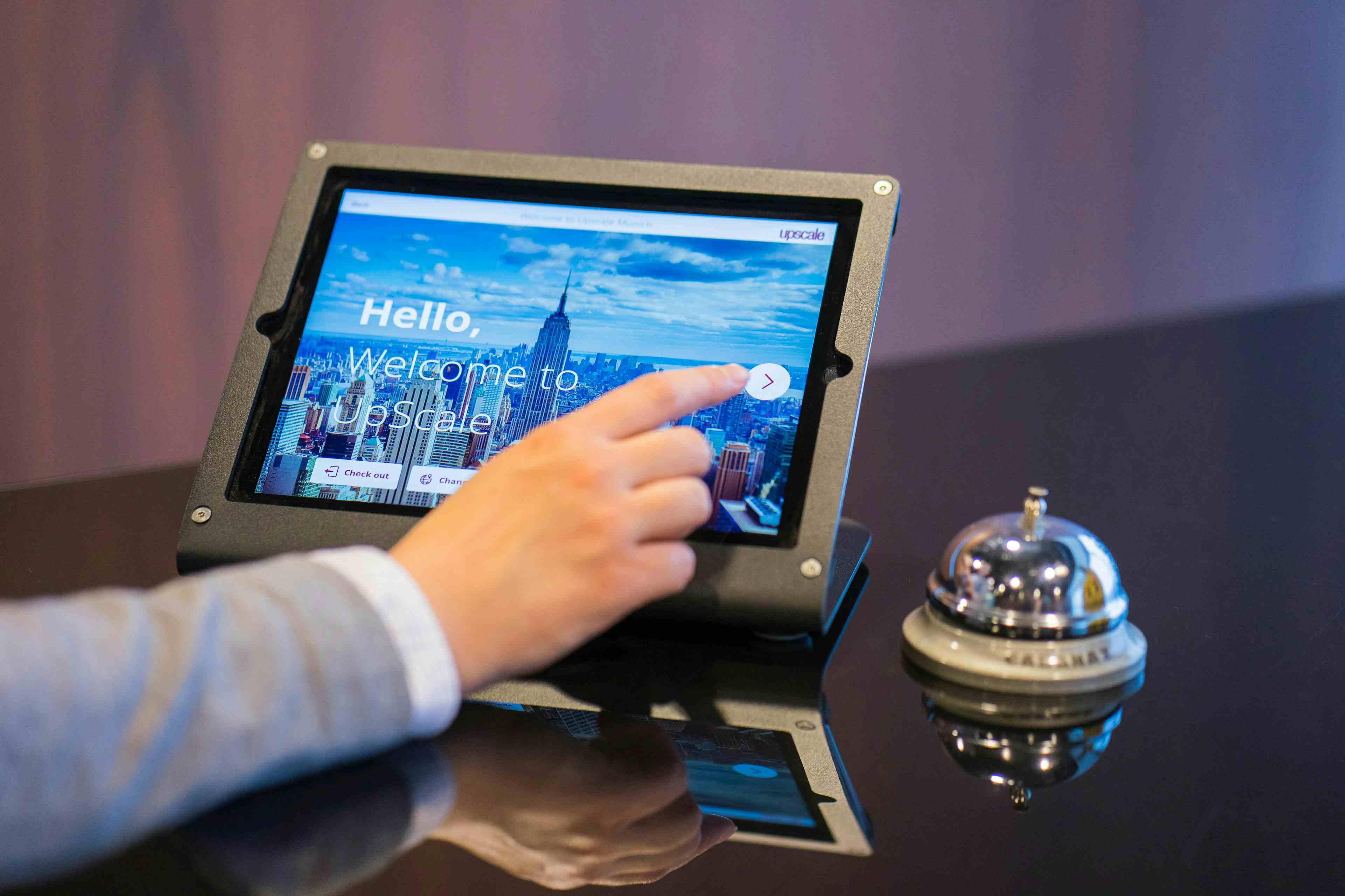 Business person working on tablet at front desk of a hotel