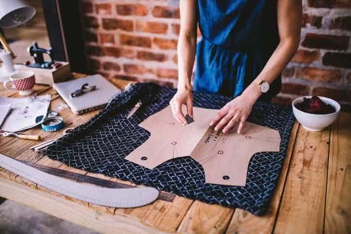 Fashion designer cutting out fabric bodice