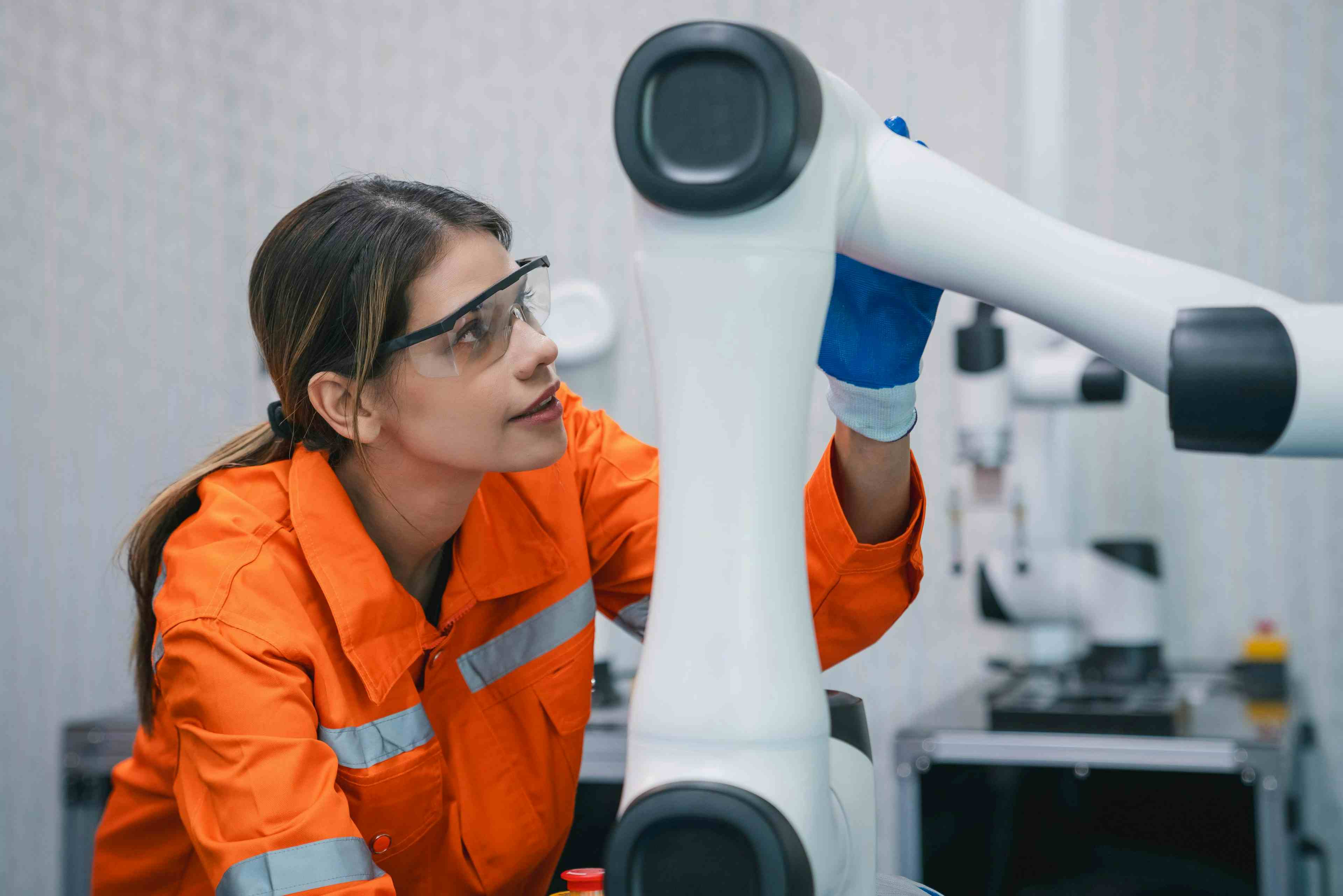 Female student engineer working with mechanical equipment