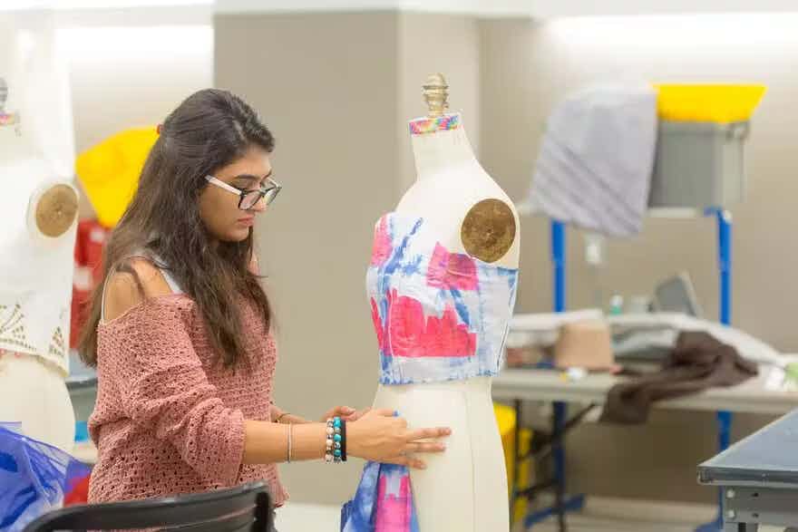 Woman draping eco-friendly fabric on a dress form
